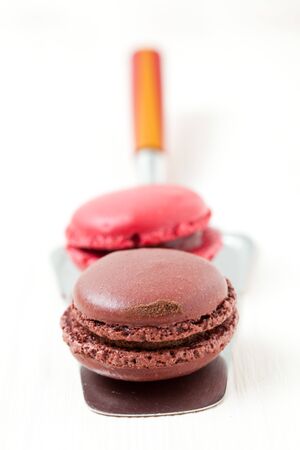 Close-up of two colorful macaroons on cake server on light backgroundの写真素材