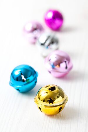 Closeup of colourful Christmas baubles on light backgroundの写真素材
