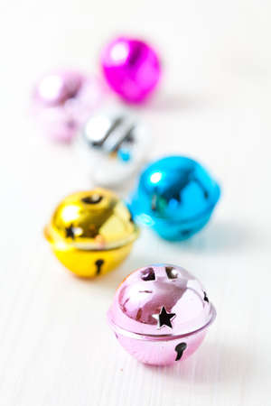 Closeup of colourful Christmas baubles on light backgroundの写真素材