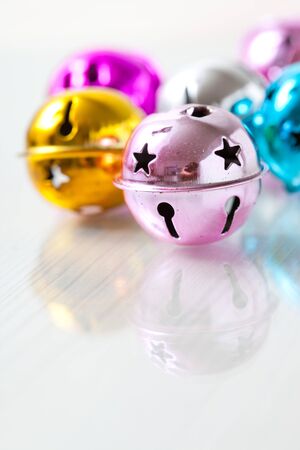 Closeup of colourful Christmas baubles on light backgroundの写真素材