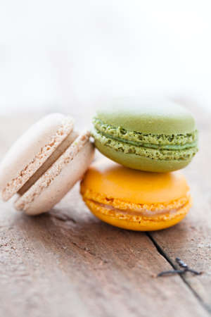 Closeup of three macaroons on wooden table surfaceの写真素材