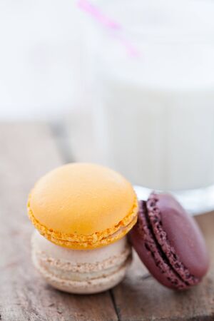 Closeup of three macaroons on wooden table surfaceの写真素材