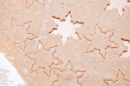 Closeup of gingerbread biscuit dough with star shapesの写真素材