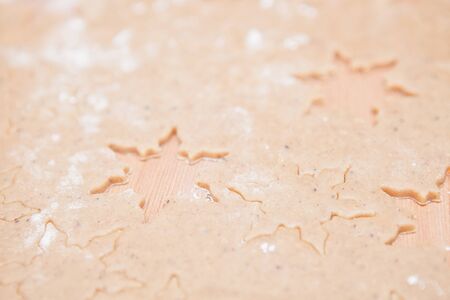 Closeup of gingerbread biscuit dough with star shapesの写真素材