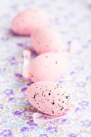 Closeup of pink Easter eggs on patterned surfaceの写真素材
