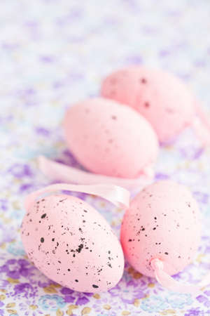 Closeup of pink Easter eggs on patterned surfaceの写真素材
