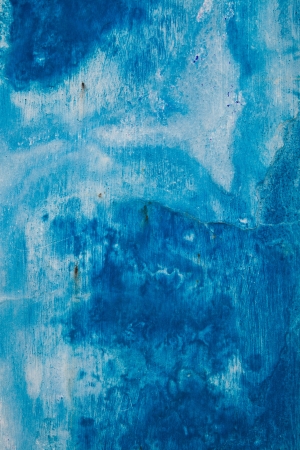 Faded blue painted wall background texture with white streaksの写真素材