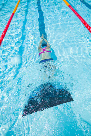 Female freediver with monofin swimming underwater in swimming poolの写真素材