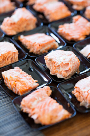 Closeup of salmon appetizers on small serving trays in rowsの写真素材