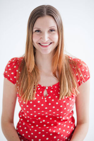 Studio portrait of happy smiling attractive woman wearing red blouseの写真素材