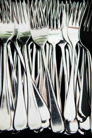 Closeup of bunch of metal silver colored eating forksの写真素材