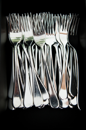 Closeup of bunch of metal silver colored eating forksの写真素材