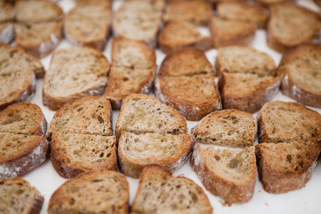 Closeup of rows of dry freshly prepared bruschetta bread の写真素材