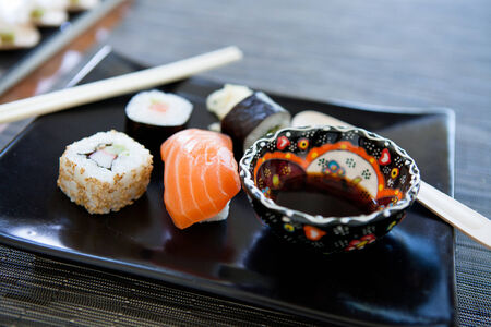 Closeup of plate of sushi with soy sauce in bowlの写真素材