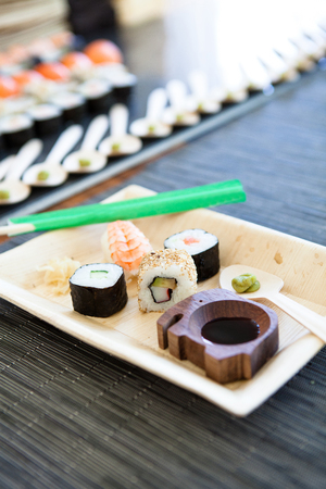 Closeup of plate of sushi with soy sauce and hot wasabi paste and fresh gingerの写真素材