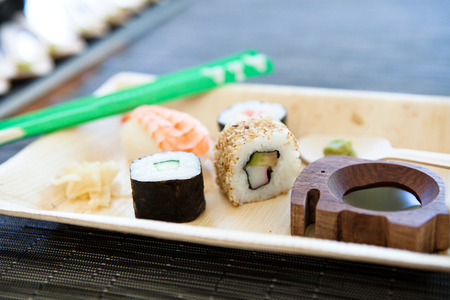 Closeup of plate of sushi with soy sauce and hot wasabi paste and fresh gingerの写真素材