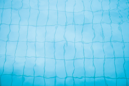Tiles on bottom of swimming pool distorted slightly by water for background imageの写真素材