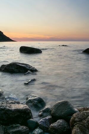 stones in the sea. sunlight on the rocksの写真素材