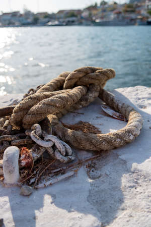 Samos island. Greece. Sea and pythagorion village background. with collorful boats. in the front a big knot and chainsの写真素材