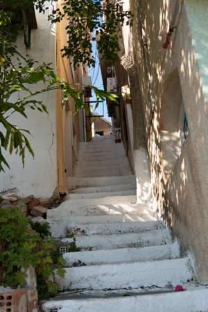 Small street with sea background and green plant. Dreamy with little balconysの写真素材