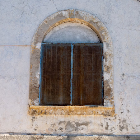 old window with an arch in a prissonの写真素材