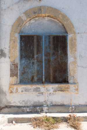 old window with an arch in a prissonの写真素材