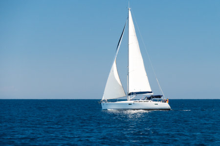 a sailingboat at sea outside the coast of Corsicaの写真素材