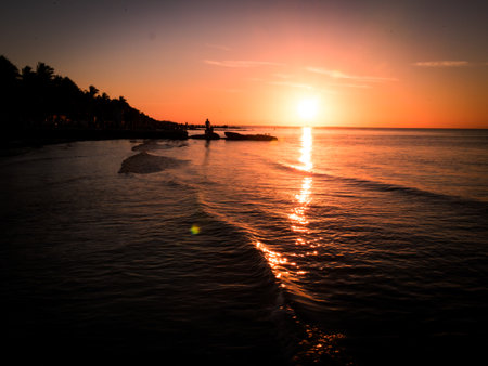 beautifal sunset at the shoreline, with boats, birds and persons at mexicoの写真素材