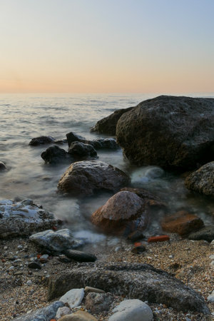 beautifal sunset at the shoreline, with boats, birds and persons at mexicoの写真素材