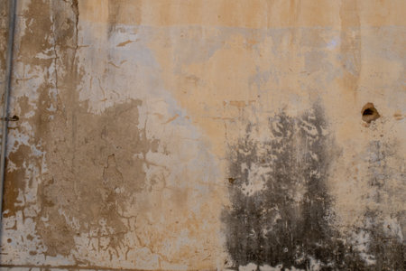 Old brick wall with peeling plaster, grunge background, brown orange and blue collors.の写真素材