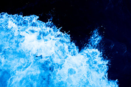 Bird's eye view on the open waters of planet earth, stormy seas, blue turquoise water of an ocean with waves and foam, abstract natural background, drone photography, copy spaceの写真素材