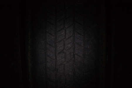 Car tires in a row on a shelf tire. Close-up in dark.の写真素材