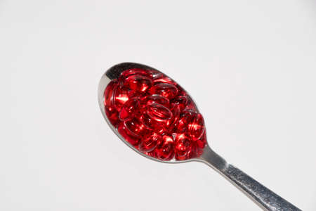 Tabs Vitamins, omega 3, Medications tablets and capsules in a beaker. Medications tablets, suppository bottles, capsules and thermometer on wooden tableの写真素材