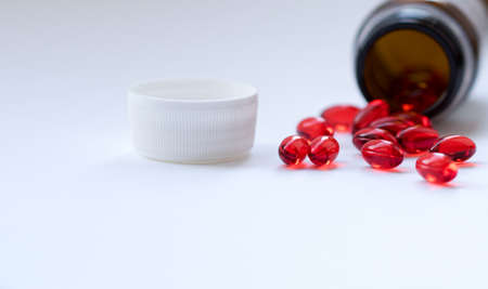 Tabs Vitamins, omega 3, Medications tablets and capsules in a beaker. Medications tablets, suppository bottles, capsules and thermometer on wooden tableの写真素材