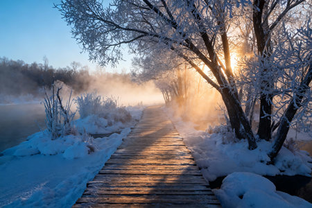 Beautiful winter landscape. Wooden bridge over the frozen lake at sunrise.の素材