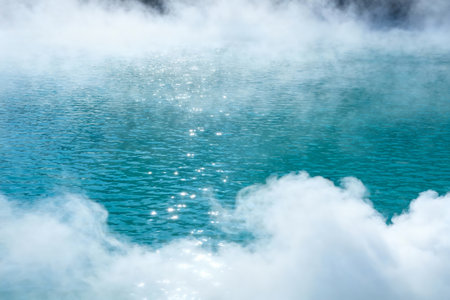 Blue hot spring with steam and reflection in the water. Natural backgroundの素材