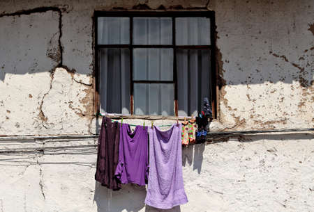 Drying laundry hanging on the wall under windowの写真素材