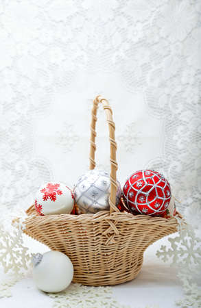 Decorative Christmas balls in a basket with lace backgroundの写真素材
