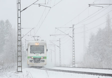 Passenger train on track in heavy snowfallのeditorial素材