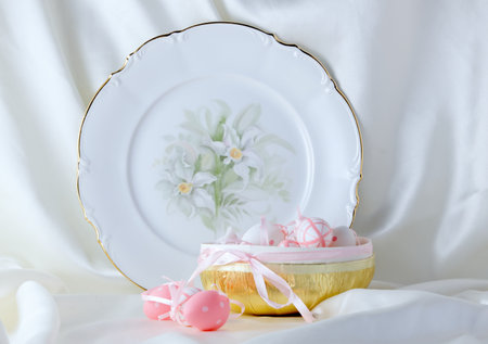 Beautiful plate and pink easter eggs on white backgroundの写真素材