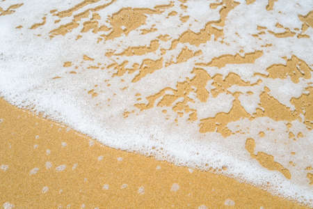 Close up of sea shore with sand and water