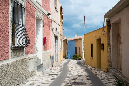 Colored houses in a narrow street in Posada, Sardinia, Italyの写真素材