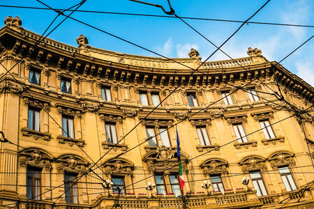 Old building with sunset light in Piazza Cordusio, Milan, Italyの写真素材