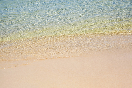 Transparent water on sandy seashore in Sardiniaの写真素材