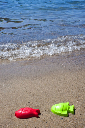 Plastic fishes on the seaside in a beach in Sardiniaの写真素材
