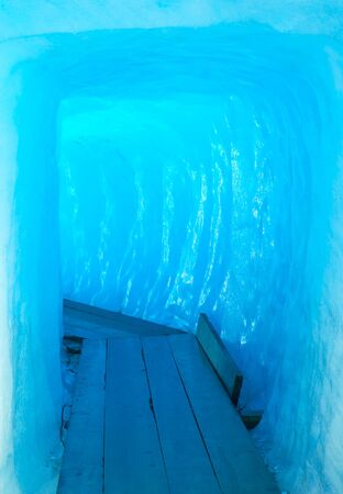 Footbridge inside the ice cave on Furka Pass,  Alps mountains, Switzerlandの写真素材
