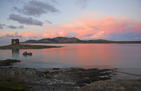 La Pelosa tower and Asinara Island at sunset, Stintino, Sardinia, Italyの写真素材