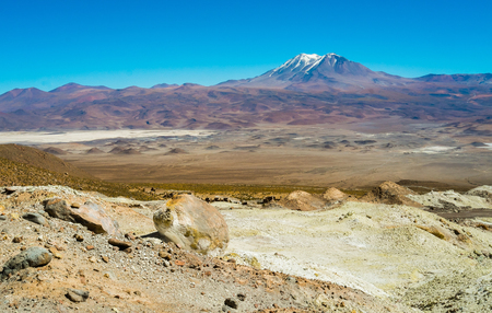 Deserted landscape with volcanoes and Salar in Ollague, border between Bolivia and Chileの写真素材