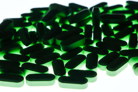 Green pills isolated on white background. Close up of green pills.の写真素材