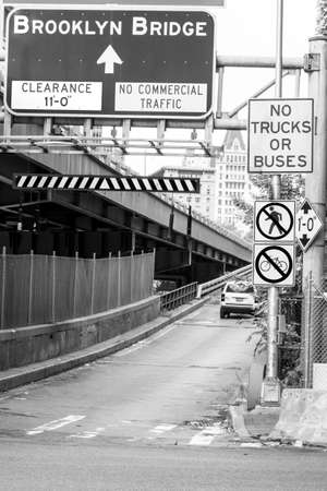 Black and white picture of a road sign on a bridge.の写真素材